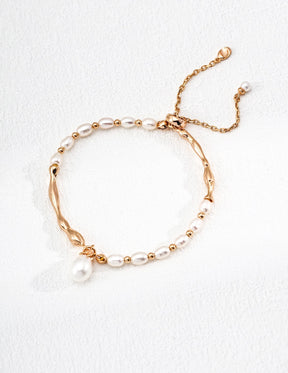 Celestial Harmony Pearl Bracelet with mixed freshwater pearls & 18k gold vermeil waves displayed on the white background.