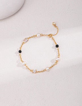 Isla 18K Gold Freshwater Pearl Zircon Black Agate Bracelet, displayed on a white surface with soft natural lighting, emphasizing its luxurious design.