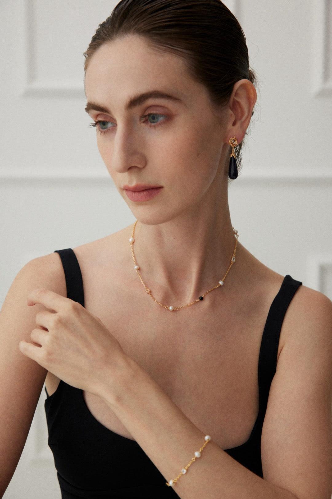 The model wears the Isla Necklace and Isla Bracelet - Lia Atelier