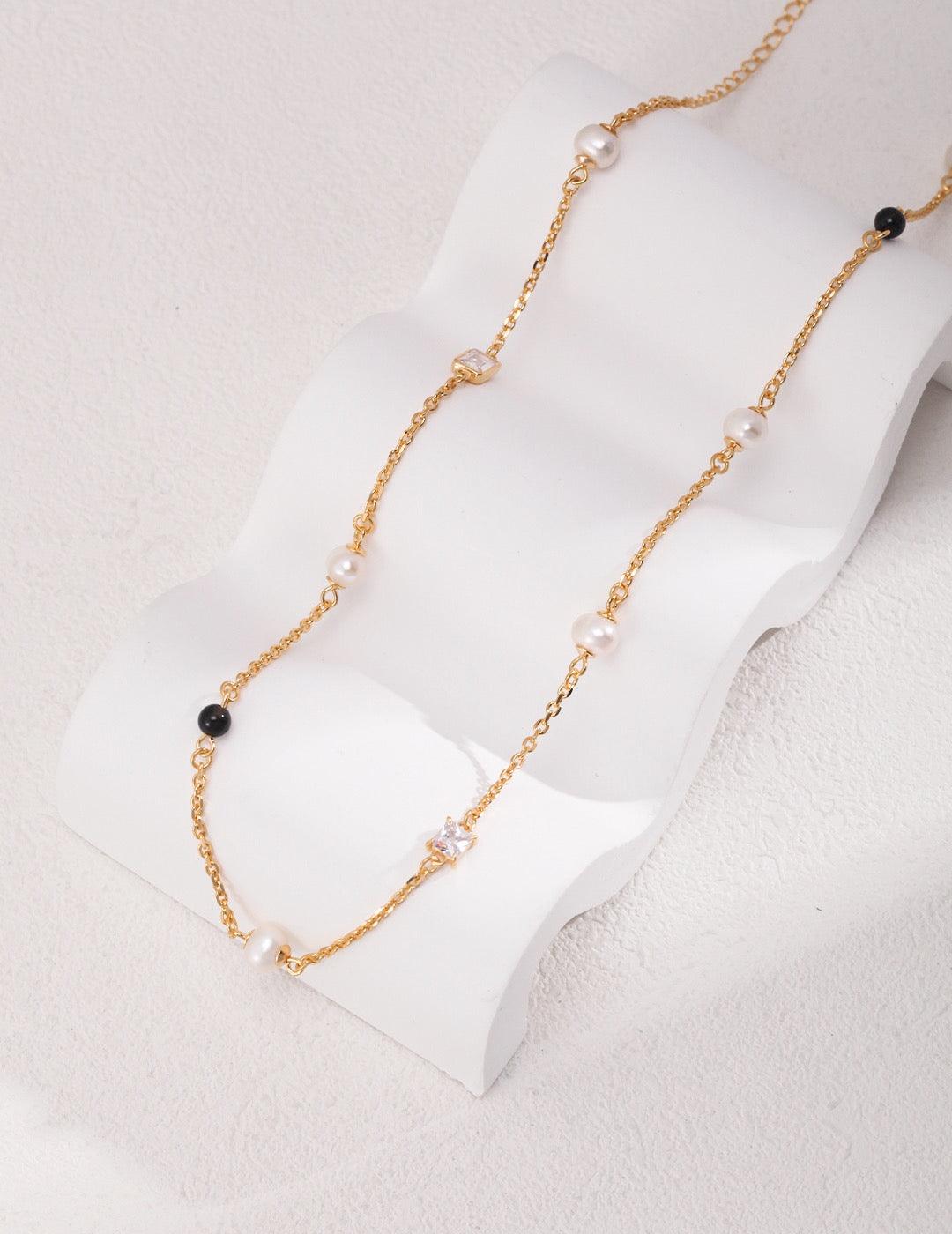 Isla Necklace, a beautiful piece featuring Freshwater Pearls, Zircon, 18k Gold Vermeil, and Black Agate. 