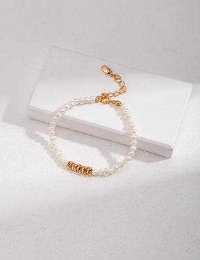 Lorelei Pearl Bracelet, with 4-4.5mm freshwater pearls and 18K gold vermeil accent beads displayed on the white rock.