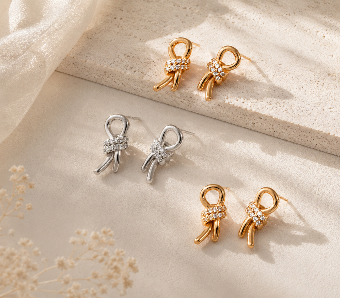 Gold vermeil and sterling silver crystal bow stud earrings displayed together