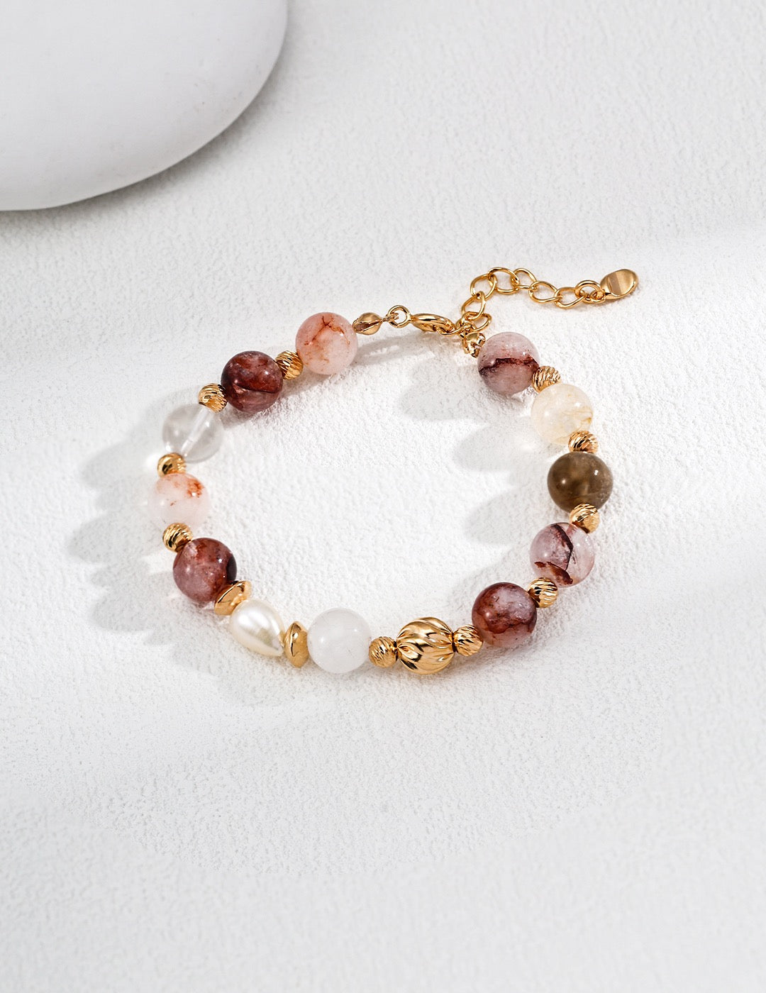 Beaded bracelet with gold accents on a white background