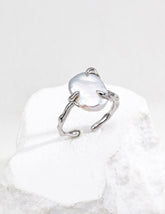 Sterling Silver baroque open ring with a central gemstone on a white background