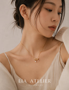 Papillon pearl butterfly necklace worn at the collarbone