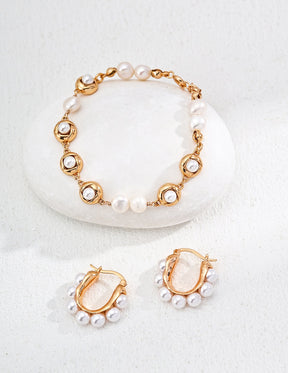 Elegant gold and pearl bracelet and hoop earrings for women.