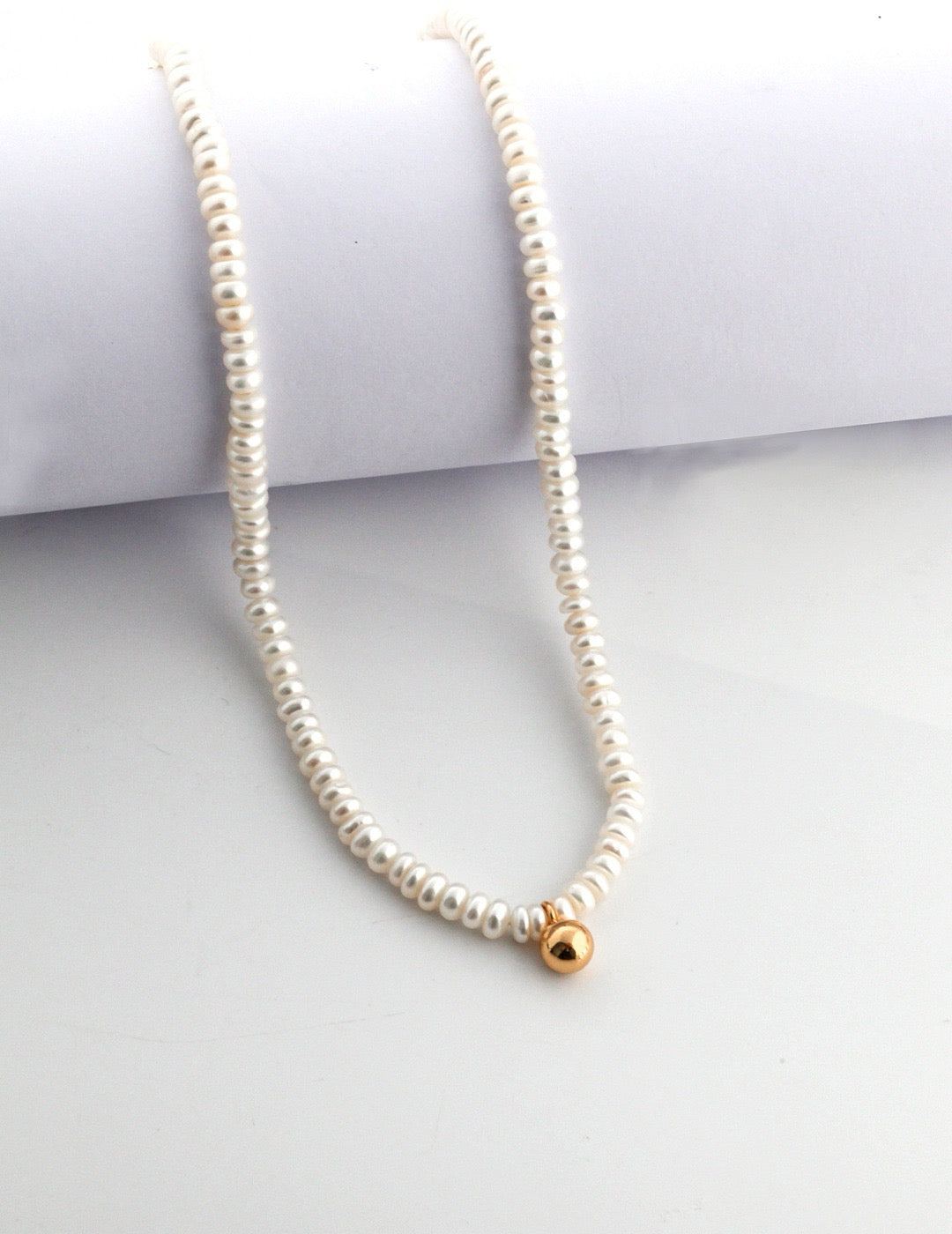 Minimalist Pearl Strand with Gold Accent displayed on the neutral background 