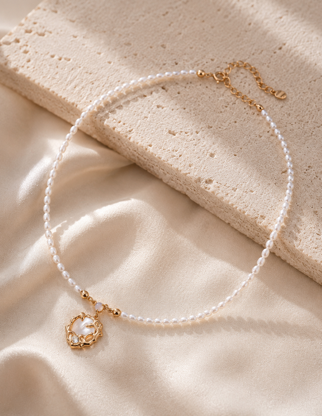 Pearl strand shell pendant necklace full view — freshwater pearl strand chain with gold vermeil lobster clasp, extender, and ornate shell medallion pendant with zircon accent
