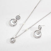 Sterling Silver Rayna Set necklace and earrings displayed on the white surface.