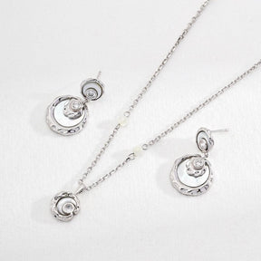 Sterling Silver Rayna Set necklace and earrings displayed on the white surface.