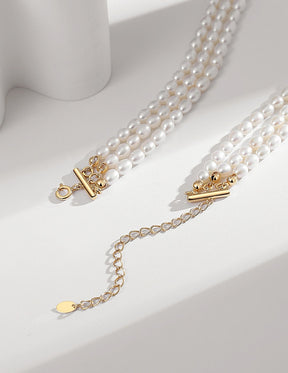 Triple Strand Pearl Choker Necklace with gold clasp on a white background