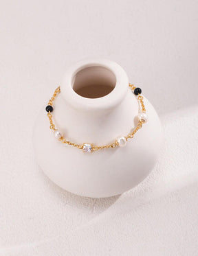 Side view of Isla 18K Gold Freshwater Pearl Zircon Black Agate Bracelet, focusing on its elegant pearl, zircon, and black agate alignment.