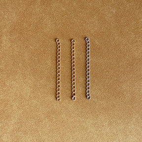 Sterling silver and 18k gold chain extensions for necklace.