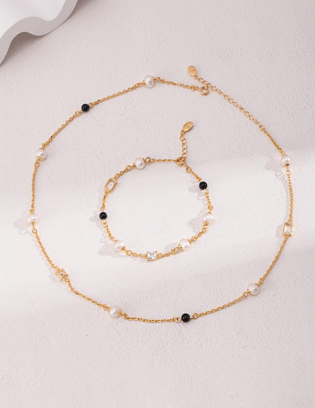 The Isla Jewelry Set, a set of necklaces and bracelets, is a beautiful piece featuring Freshwater Pearls, Zircon, 18k Gold Vermeil, and Black Agate, also as Feng Shui Jewelry.