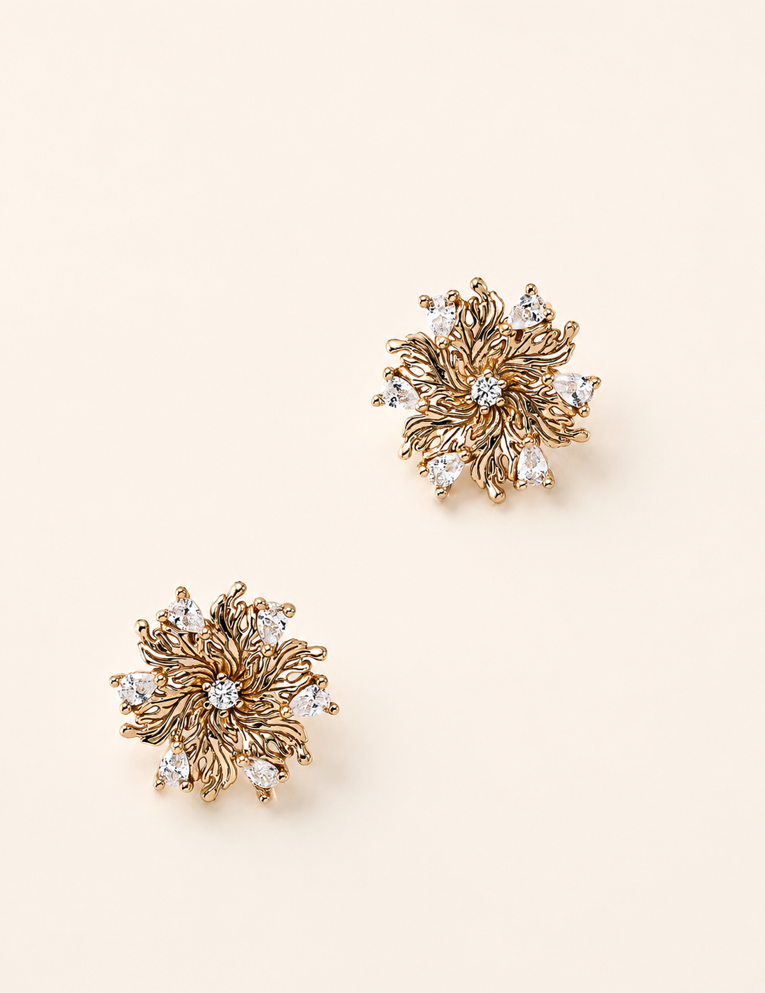 Elowen Radiant Bloom zircon flower stud earrings on an ivory background