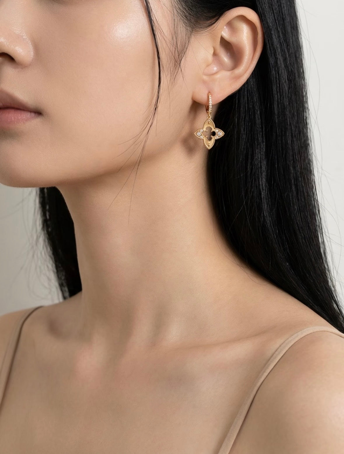 Four Leaf Clover drop earrings in 18K gold vermeil with milgrain detail and zircon accents on model