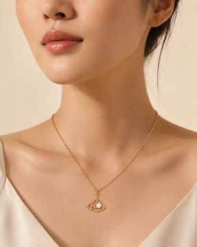 Ginkgo leaf pearl pendant necklace worn on model with adjustable gold vermeil chain