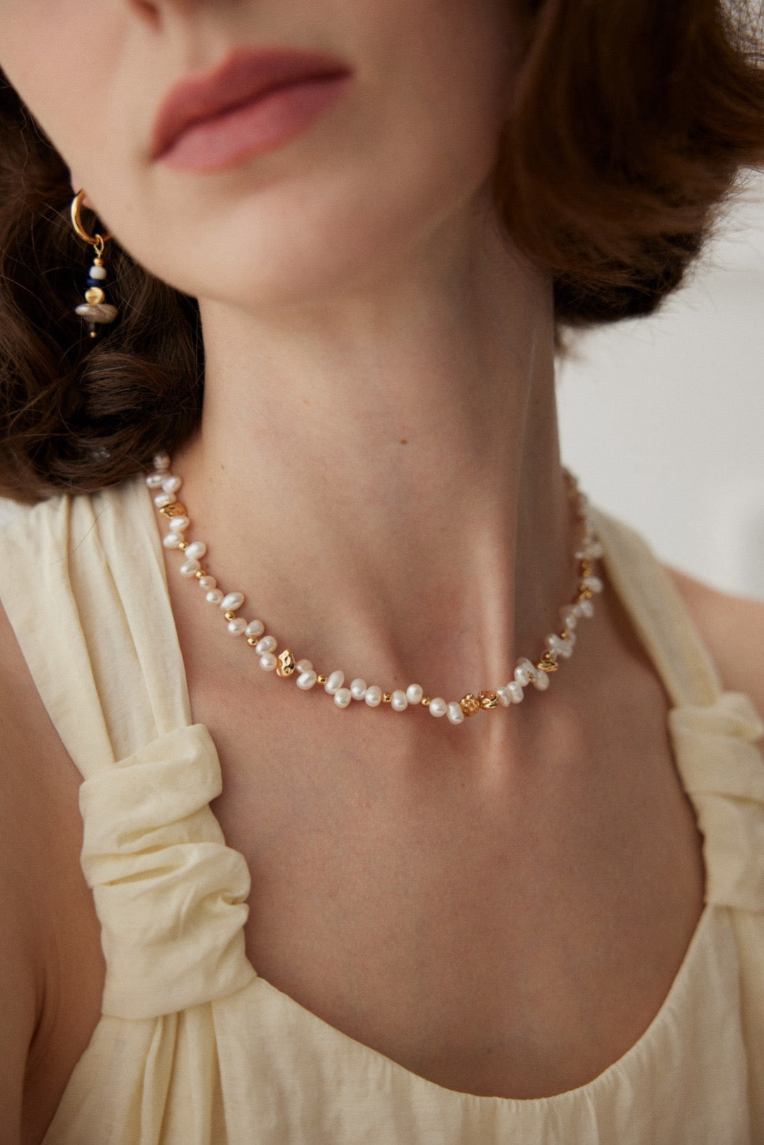 Jasmine Pearl Necklace close-up on model, with freshwater pearls and sculptural 18K gold vermeil accents