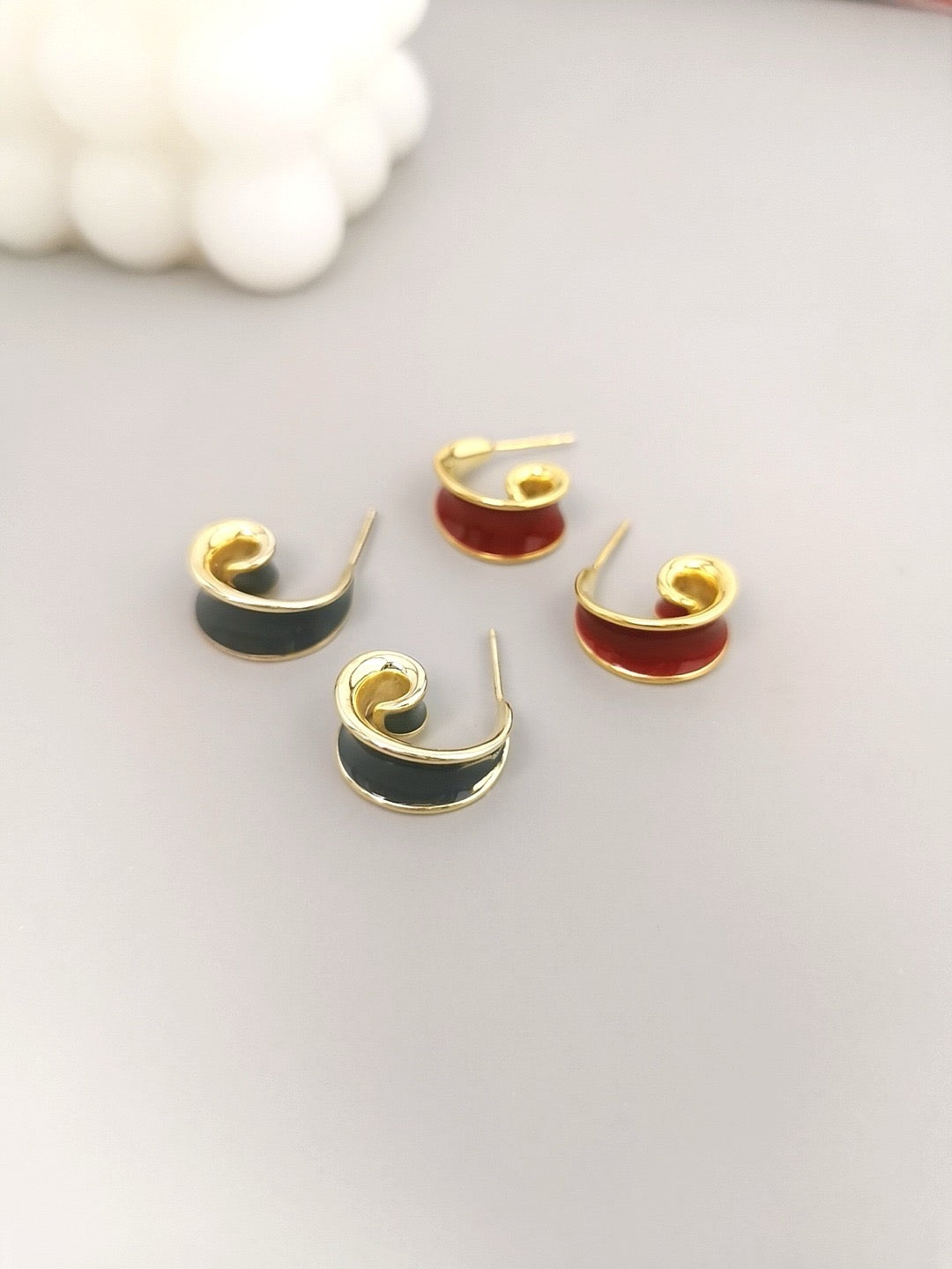 Pair of gray and red hoop earrings on a light gray background