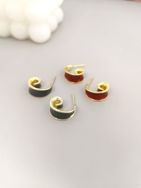 Pair of gray and red hoop earrings on a light gray background